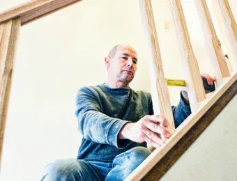 A Sartes carpenter setting stair stringers on site